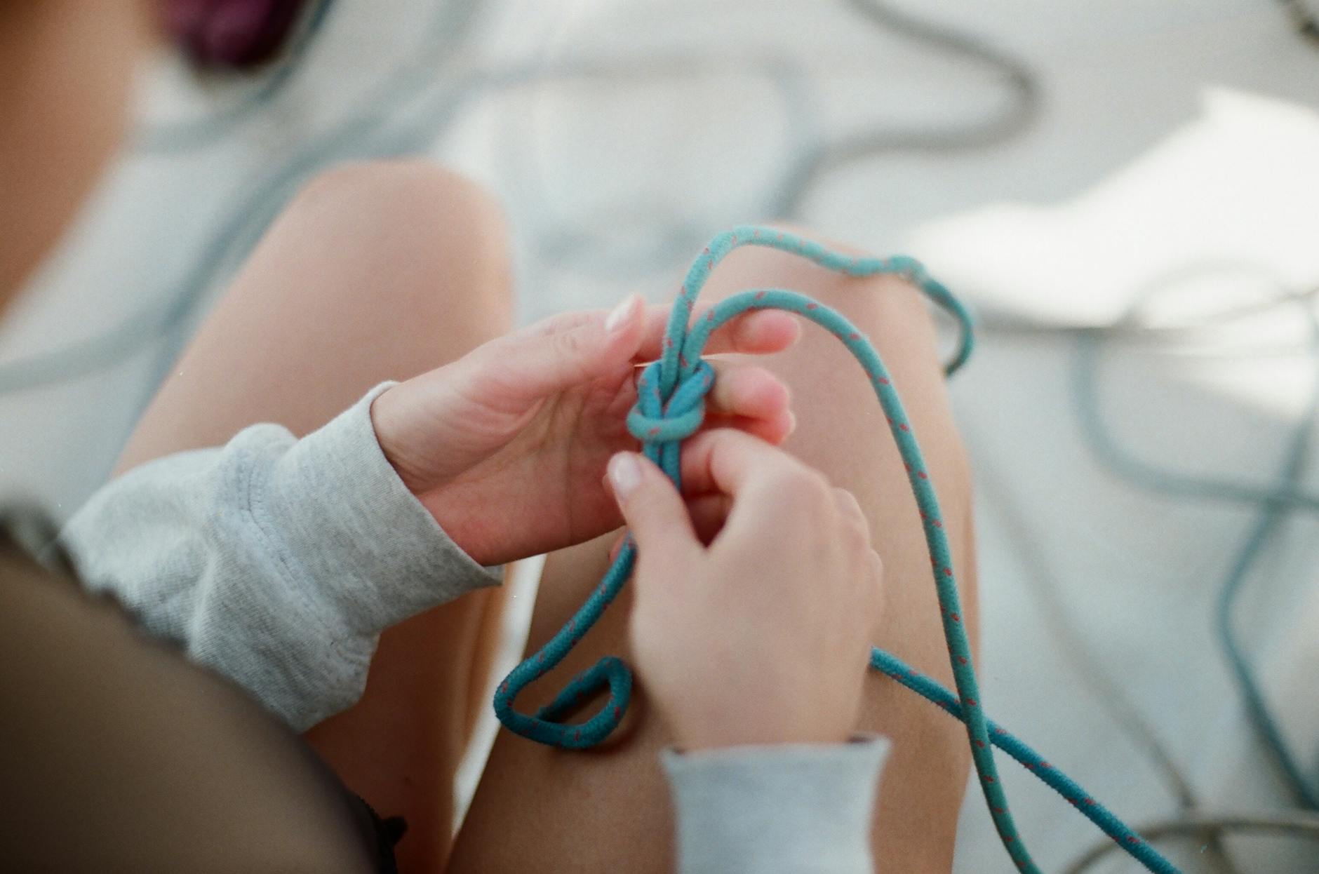 woman tying silk scarf